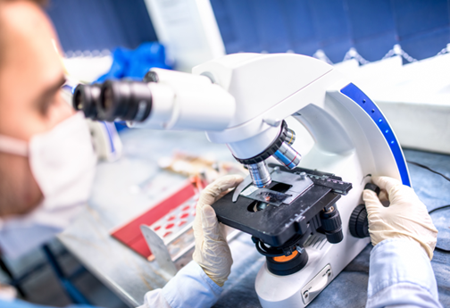 medical researcher using the microscope